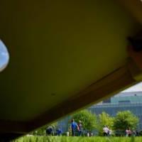 The cornhole tournament begins in the background from a view under a cornhole board